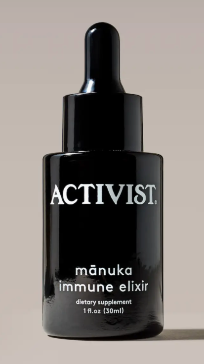 Black dropper bottle labeled 'Activist manuka immune elixir' on a beige background