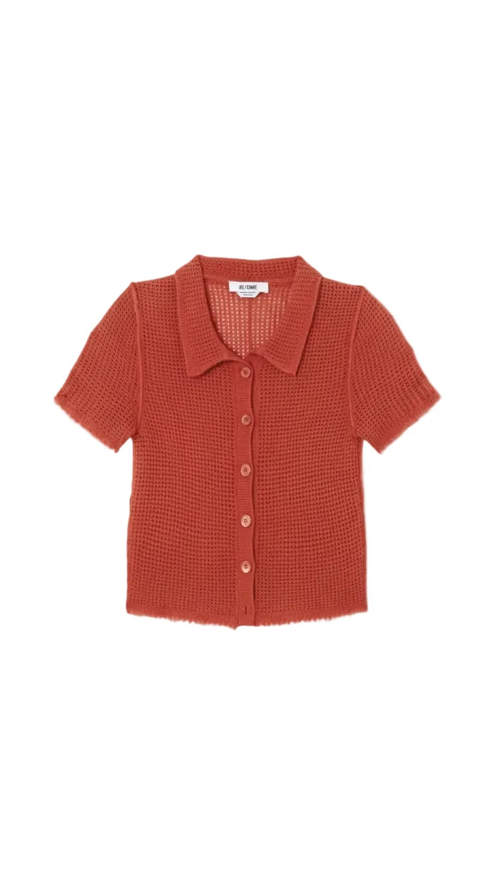 Red textured shirt on a light gray background