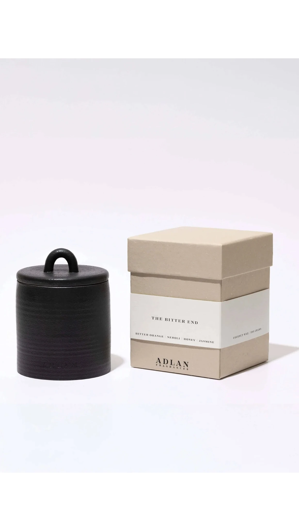Black cylindrical container with a lid next to a beige box labeled 'The Bitter End' by 'Adlan' on a white background