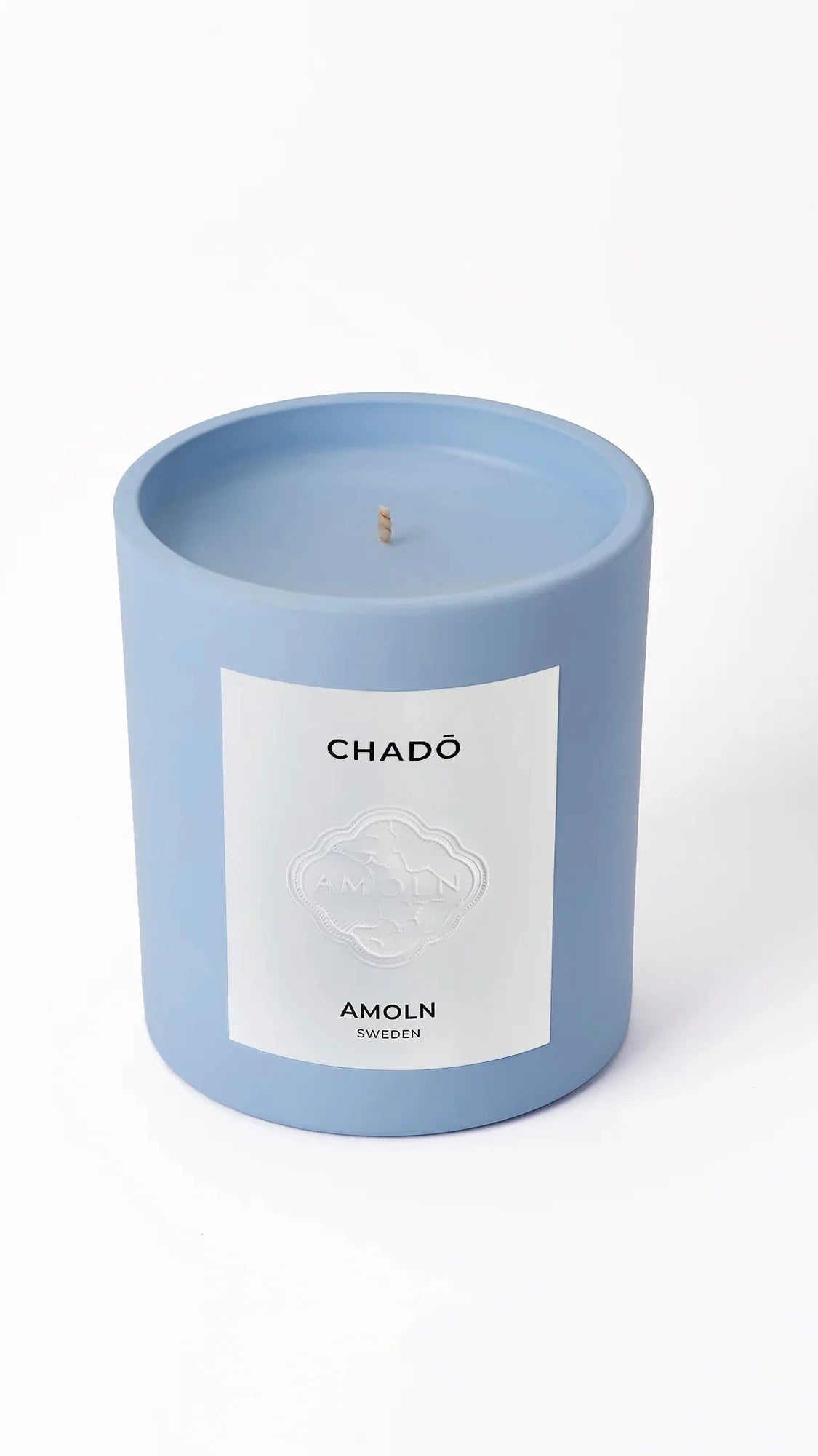 Blue candle with a label on a white background