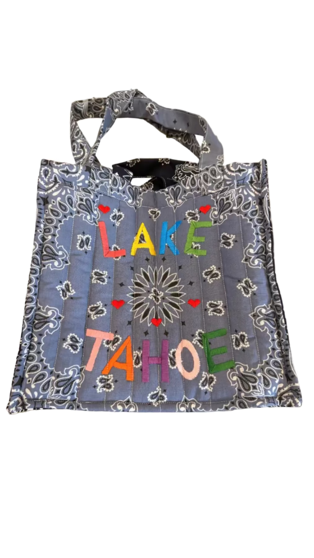 Blue bandana-style bag with 'Lake Tahoe' text on a concrete surface