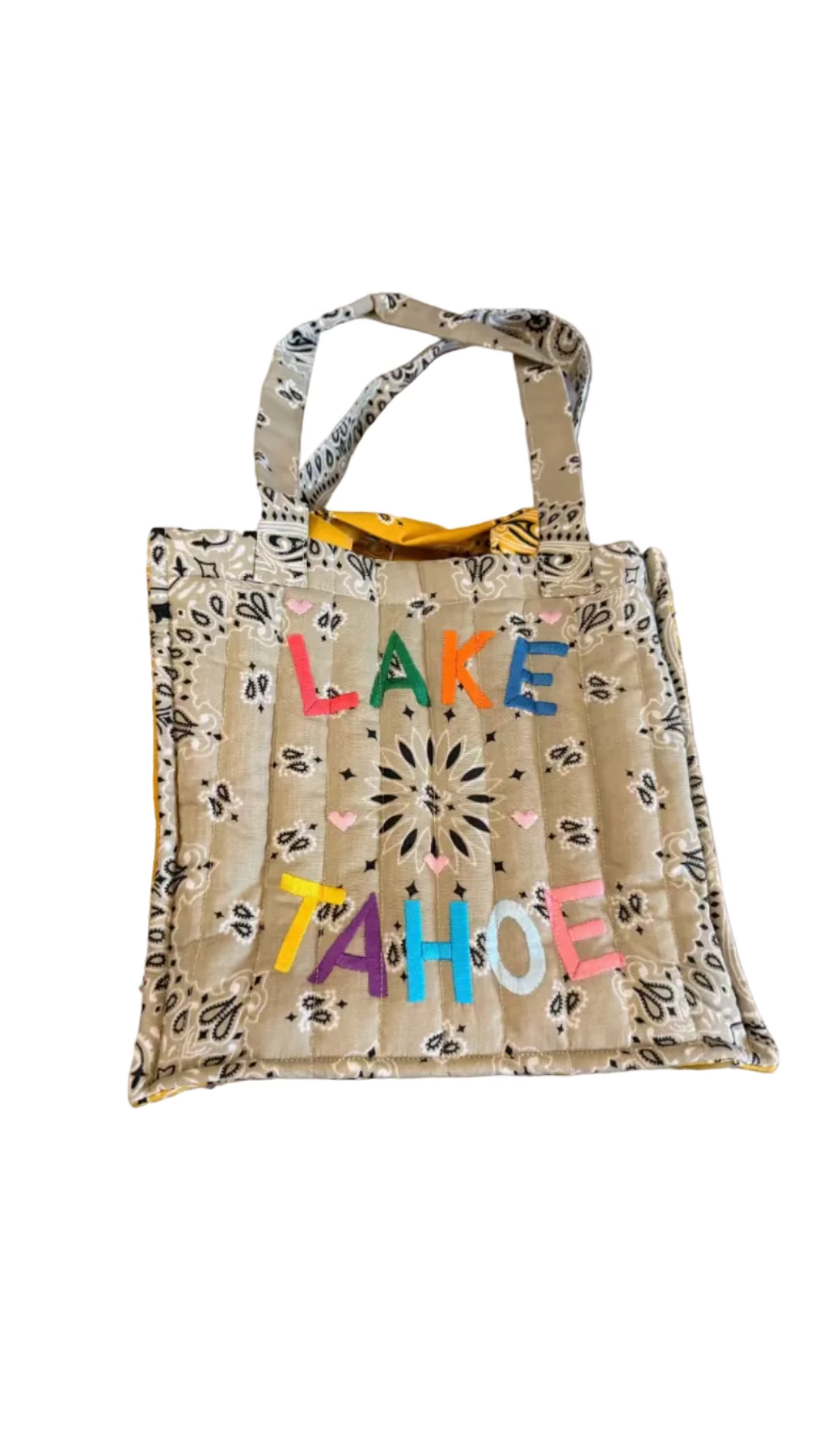Tote bag with 'Lake Tahoe' text on a concrete surface