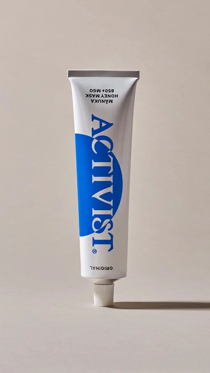 Tube of Activist product on a beige background