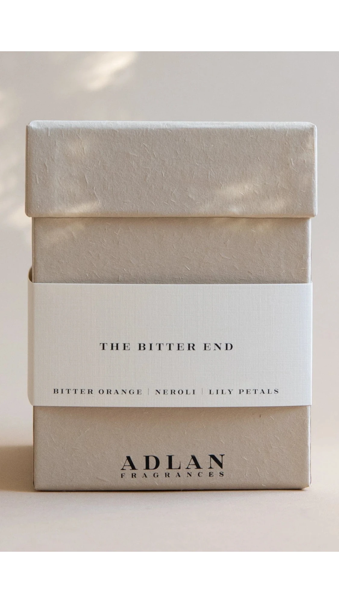 Beige box with 'The Bitter End' and 'Adlan Fragrances' text on a light background